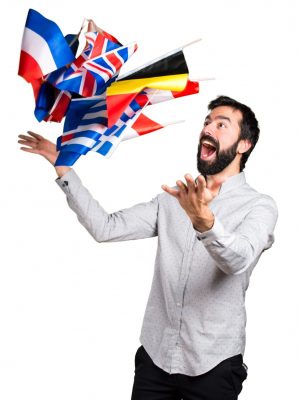 happy-handsome-man-with-beard-holding-many-flags